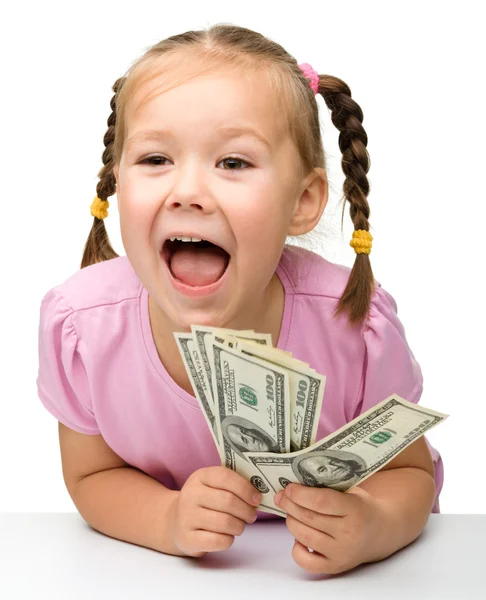 Söt liten flicka med papperspengar - dollar — Stockfoto