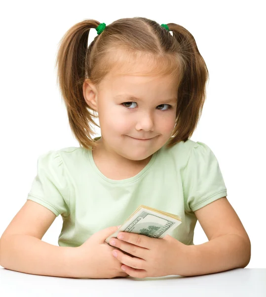Niedliches kleines Mädchen mit Papiergeld - Dollars — Stockfoto