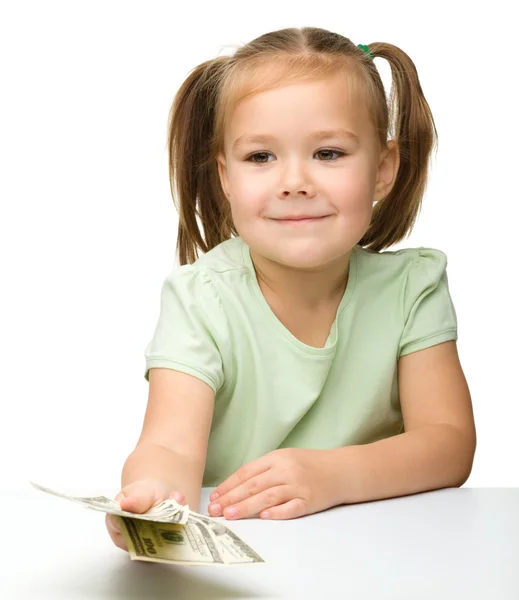 Linda niña con papel moneda - dólares —  Fotos de Stock