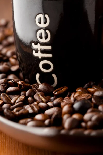 Coffee mug with coffee beans — Stock Photo, Image
