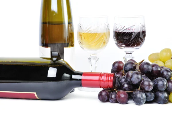 Two bottles of wine with two glasses of wine and grapes isolated in white — Stock Photo, Image