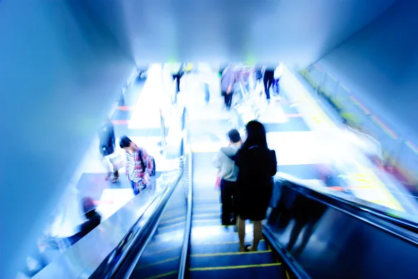 Passenger on moving escalator Stock Picture