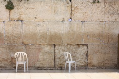 Since ancient time jew came to western wall with his plastic chair clipart