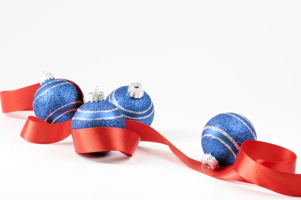 Christmas balls and red ribbon — Stock Photo, Image