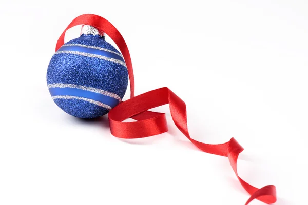 Christmas ball and red ribbon — Stock Photo, Image