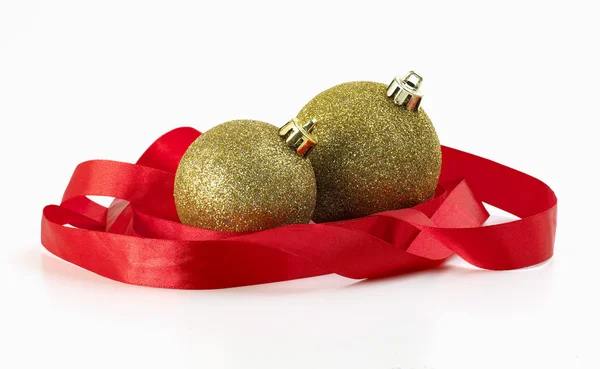 Christmas balls wrapped in red ribbon Royalty Free Stock Images