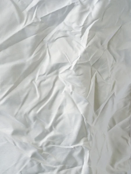Oberfläche aus faltigem weißen Tuch — Stockfoto