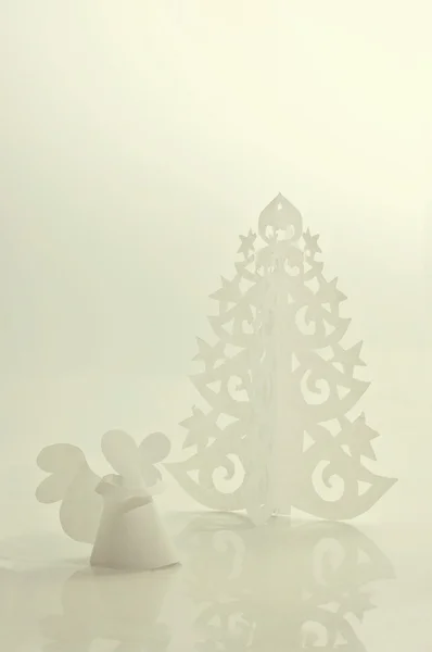 Handmade angel and Christmas tree cut out from office paper — Stock Photo, Image