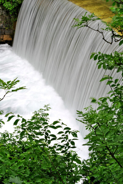 River with waterfall and rapid and violent white foam and clean