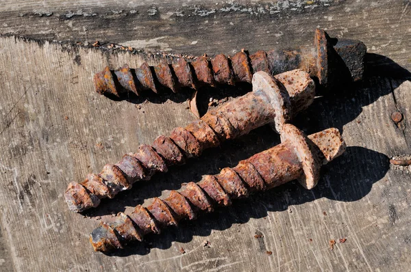 Rusty screws on old board — Stock Photo, Image