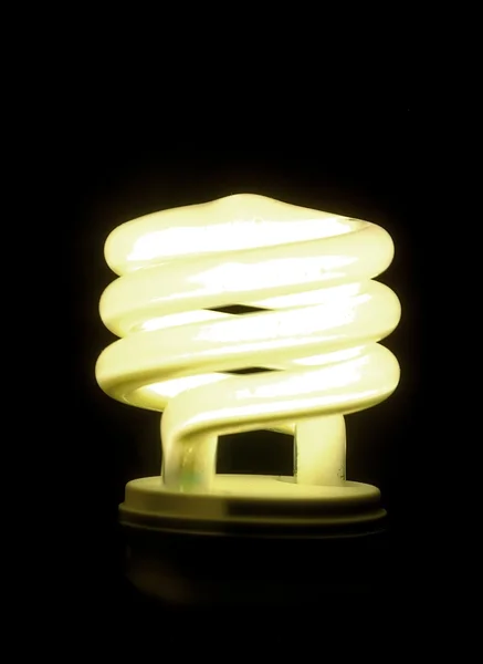 Lighted bulb on black background — Stock Photo, Image
