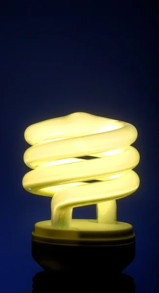 Lighted bulb on black background — Stock Photo, Image