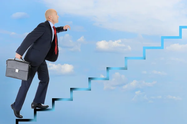 Businessman runs up the career ladder — Stock Photo, Image