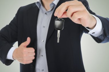 Businessman gives the keys to the car clipart