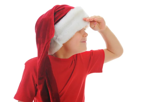 Ragazzo allegro in cappello di Babbo Natale — Foto Stock