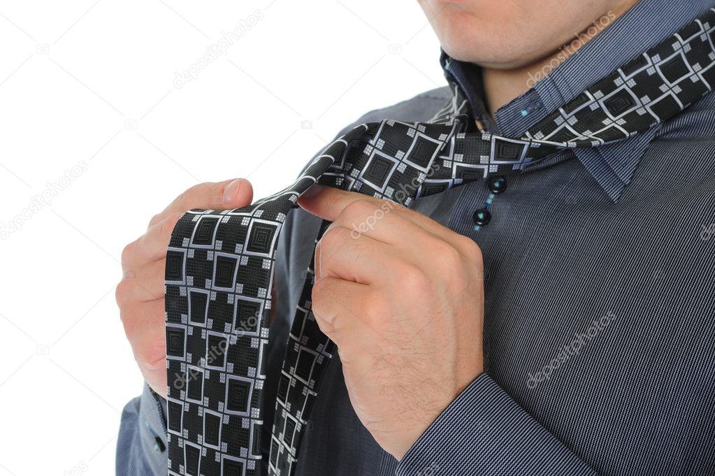 Businessman tying his tie