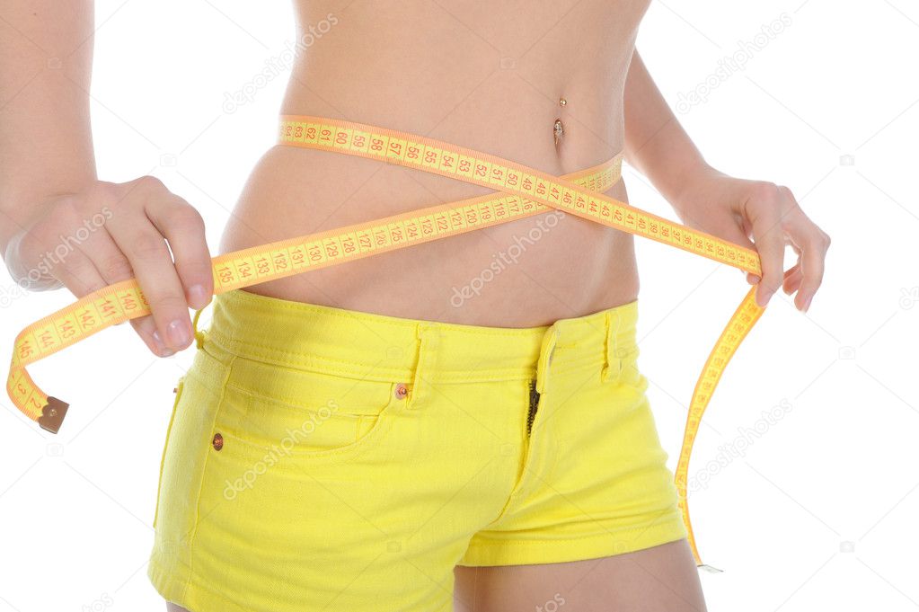 Young sports woman measuring waist.