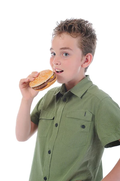 Pikkupoika syö hampurilaista. — kuvapankkivalokuva