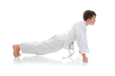 Young boy training karate. clipart