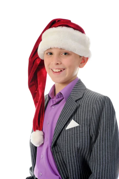 Fröhlicher Junge mit Weihnachtsmann-Hut Stockbild