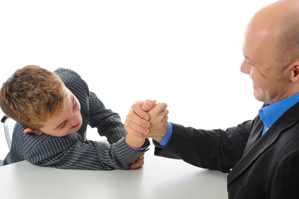 Boy and a man arm wrestling Royalty Free Stock Images