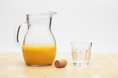 Orange Juice in Flagon with Glass and Cork clipart