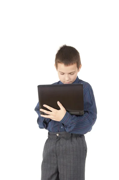 El adolescente tiene el control sobre el portátil —  Fotos de Stock