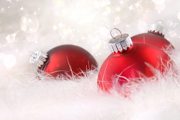 Red Christmas balls in white feathers Stock Picture