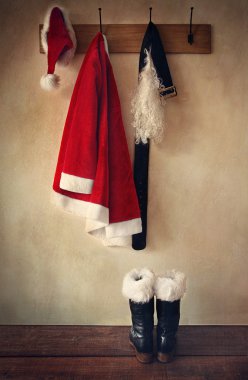 Santa costume with boots on coat hook clipart