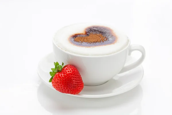 Cappuccino in a cup in the shape of hearts and strawberries isol — Stock Photo, Image