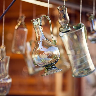 Decanters of bohemian glass hanging on hooks clipart