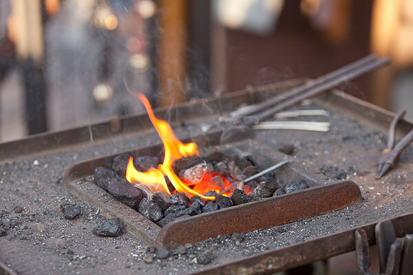 Embers, fire, smoke and blacksmith tools