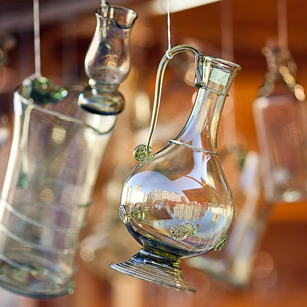 Decanters of bohemian glass hanging on hooks — Stock Photo, Image