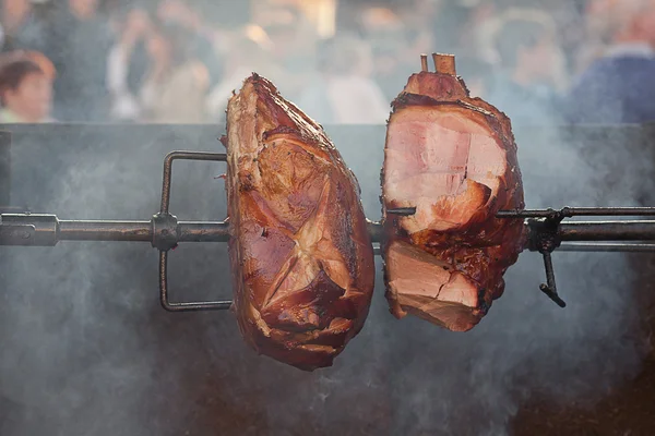 Огромные куски свинины, жарящиеся на вертеле — стоковое фото