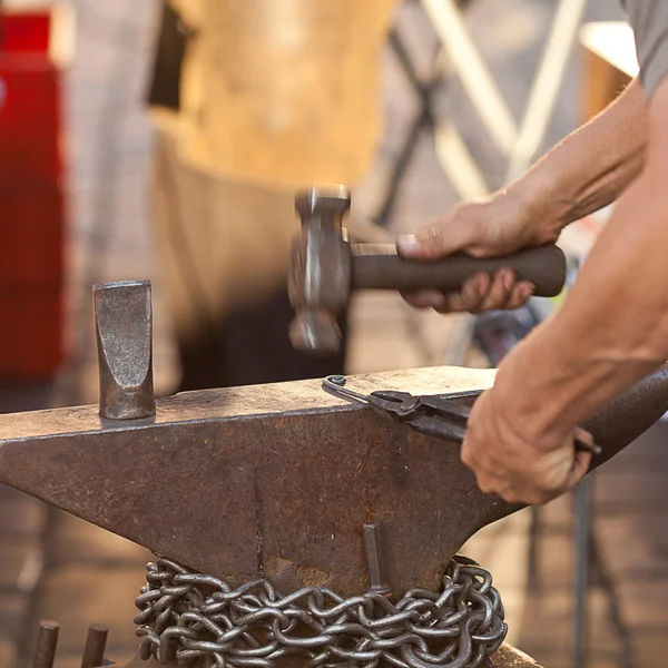 Hammer, anvil and the hands of a blacksmith — Stock Photo, Image