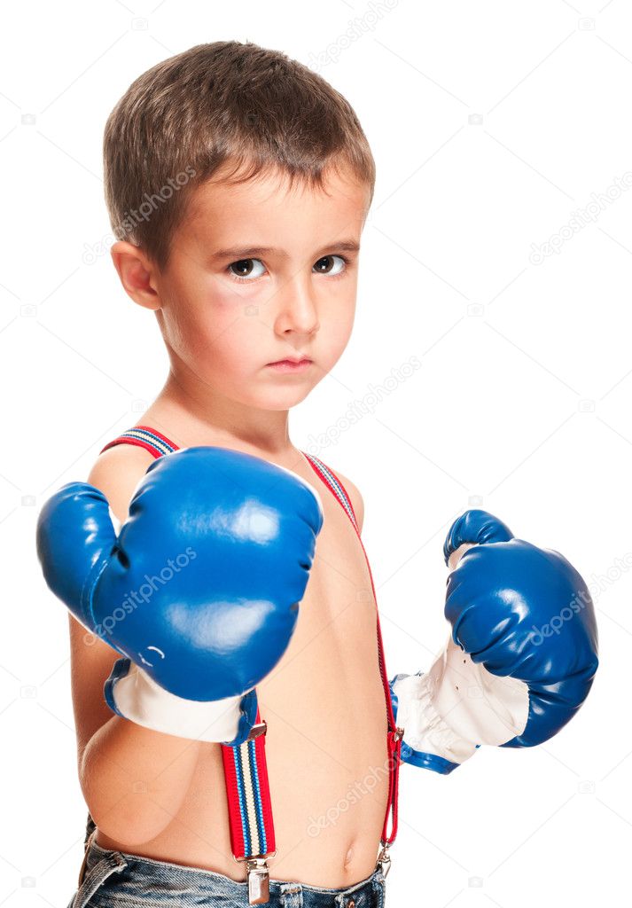 Little bully boy with black eye in boxing gloves fighting stance