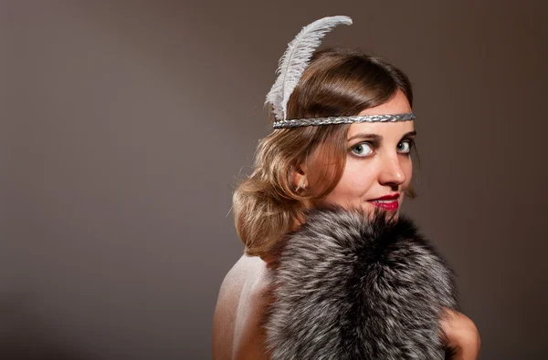 Retro woman with feather and fur — Stock Photo, Image