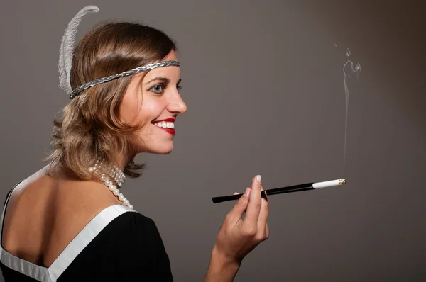 Retro woman in pearls with cigarette mouthpiece — Stock Photo, Image