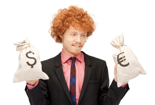 Man with euro and dollar bags — Stock Photo, Image