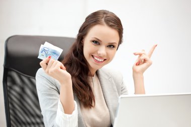 Happy woman with computer and euro cash money clipart