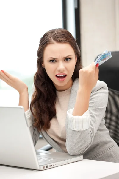 Unhappy woman with computer and euro cash money — Stock Photo, Image