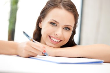 Happy woman with big notepad clipart