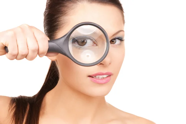 Woman with magnifying glass Royalty Free Stock Images