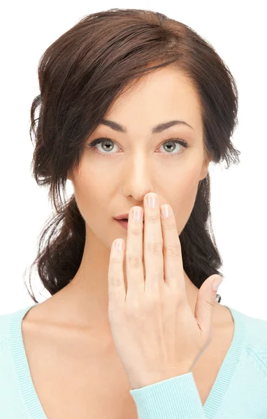 Woman with hand over mouth — Stock Photo, Image