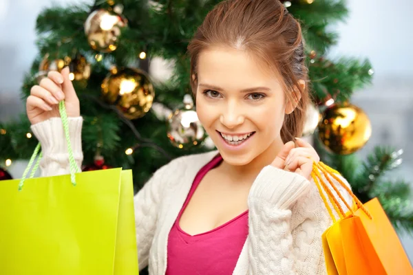 Mulher feliz com sacos de compras e árvore de Natal — Fotografia de Stock