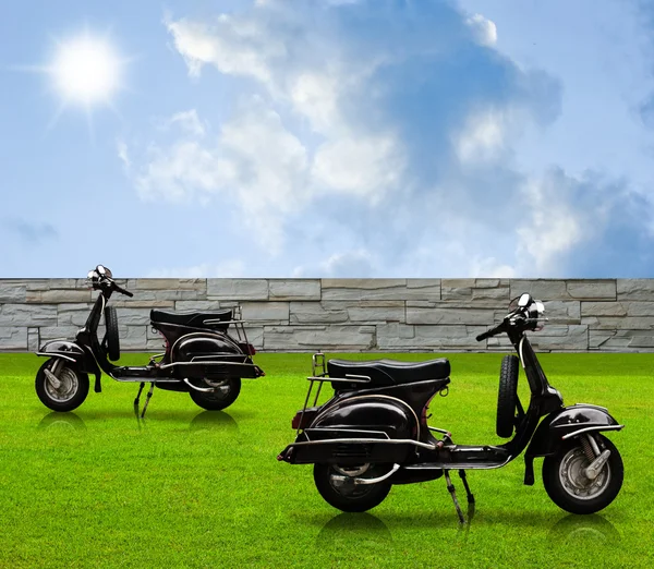 Black vintage motorbike in the garden — Stock Photo, Image