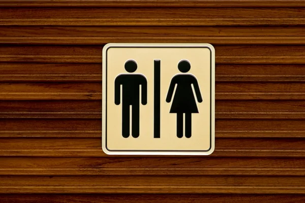 Toilet sign on wooden wall — Stock Photo, Image