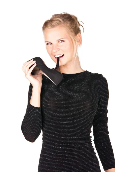 Picture of a girl in black dress with a shoe in her hand — Stock Photo, Image