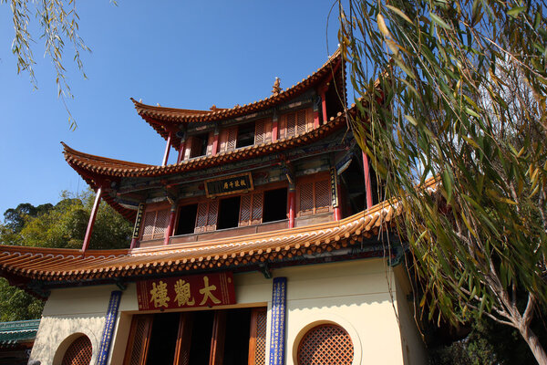 Ancient Chinese architecture against the blue sky in Kunming, China.