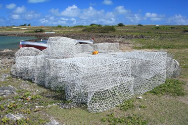 Fish traps stacked in the open; Rodrigues Island clipart